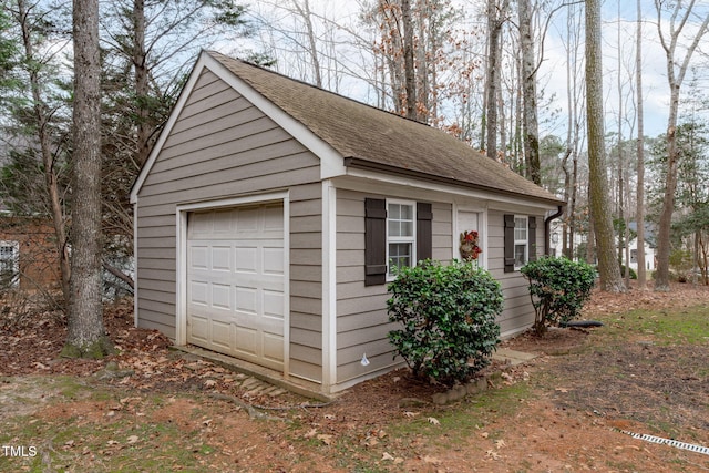 exterior space with a garage and an outdoor structure