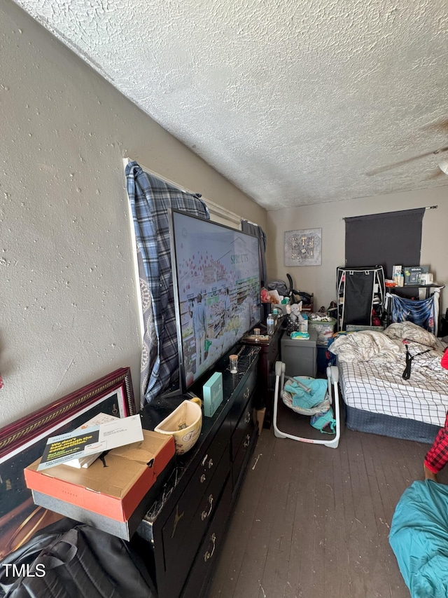 bedroom featuring hardwood / wood-style flooring and a textured ceiling