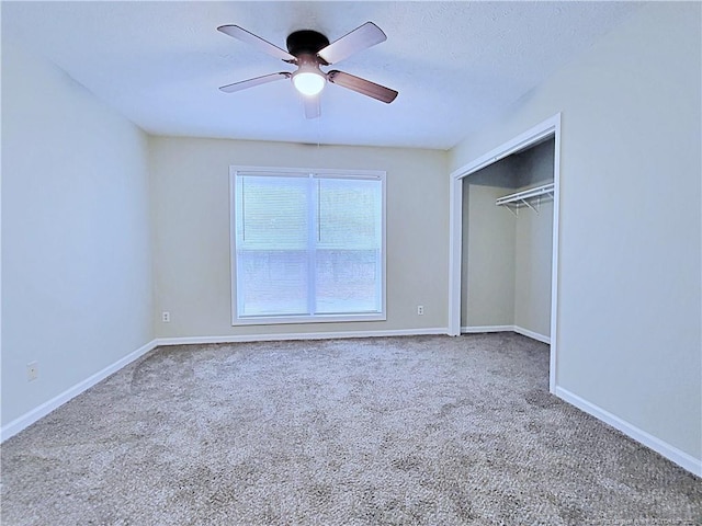 unfurnished bedroom with ceiling fan, a closet, and carpet