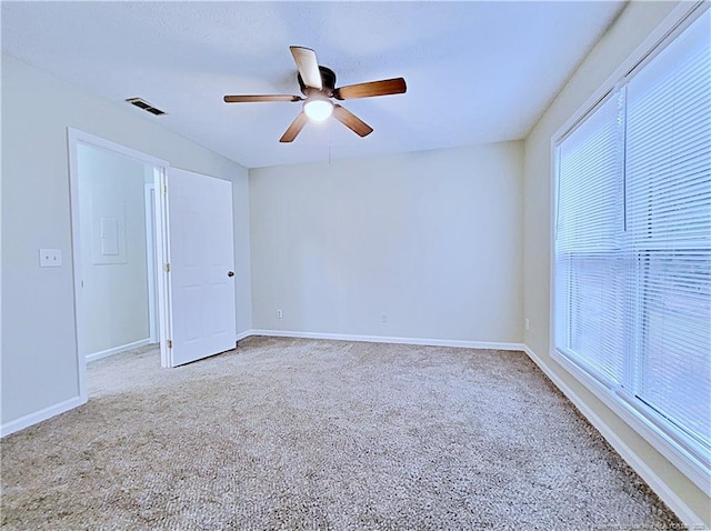 carpeted empty room featuring ceiling fan