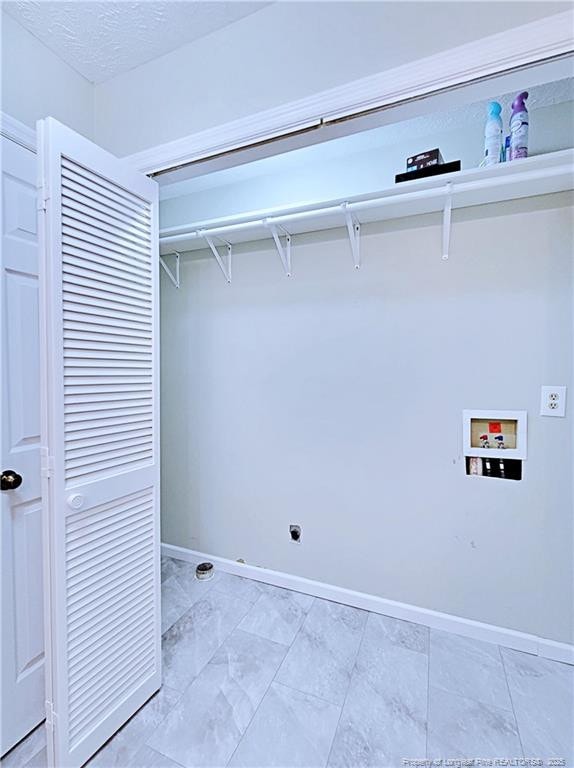 washroom featuring washer hookup and a textured ceiling