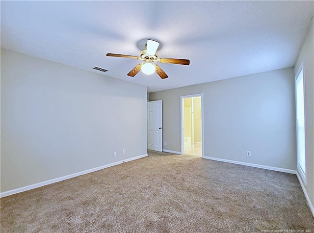 unfurnished room featuring ceiling fan and carpet floors