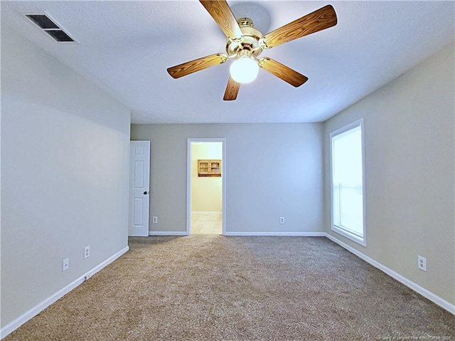 carpeted empty room with ceiling fan