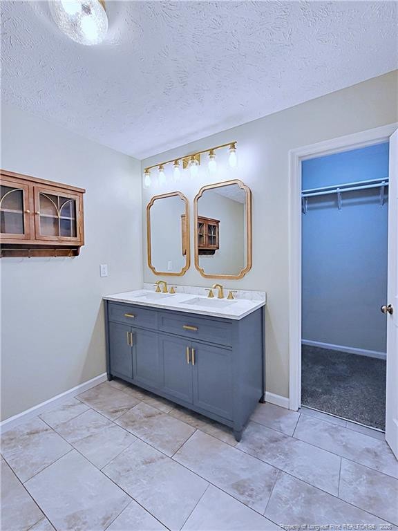 bathroom featuring vanity and a textured ceiling