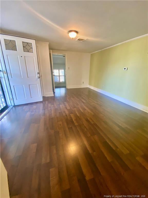 empty room with dark hardwood / wood-style flooring