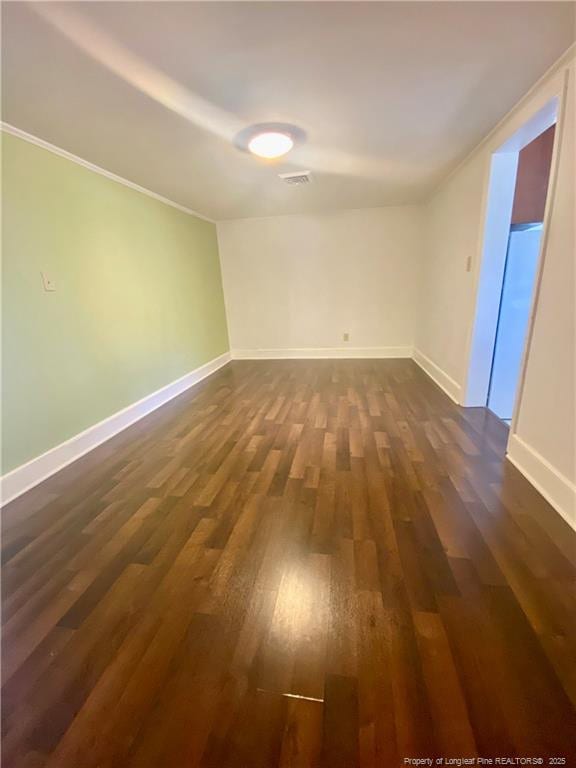 empty room featuring dark hardwood / wood-style flooring