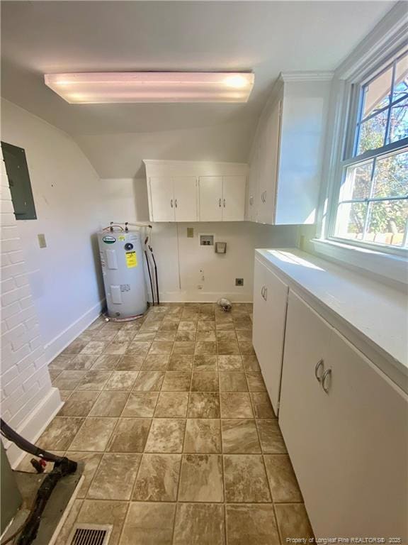 washroom featuring water heater, cabinets, washer hookup, electric panel, and hookup for an electric dryer