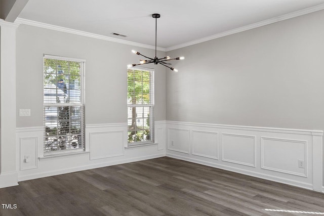 unfurnished dining area featuring ornate columns, ornamental molding, dark wood-type flooring, and an inviting chandelier