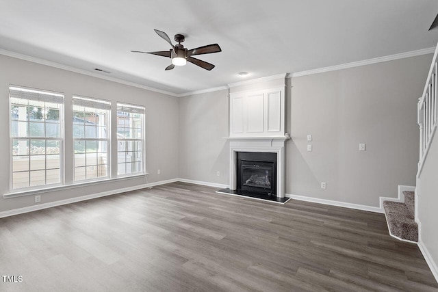 unfurnished living room featuring crown molding, wood-type flooring, and a fireplace