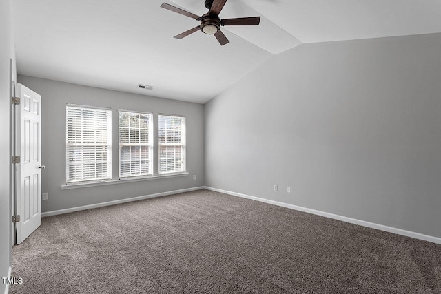 carpeted spare room with ceiling fan and lofted ceiling