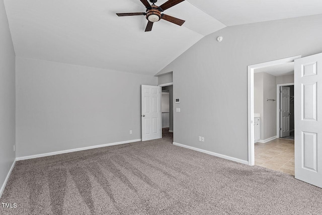 unfurnished bedroom featuring ceiling fan, lofted ceiling, and light carpet