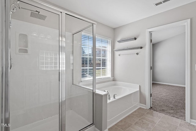 bathroom with shower with separate bathtub and tile patterned floors