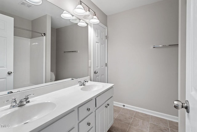 bathroom with vanity and tile patterned flooring