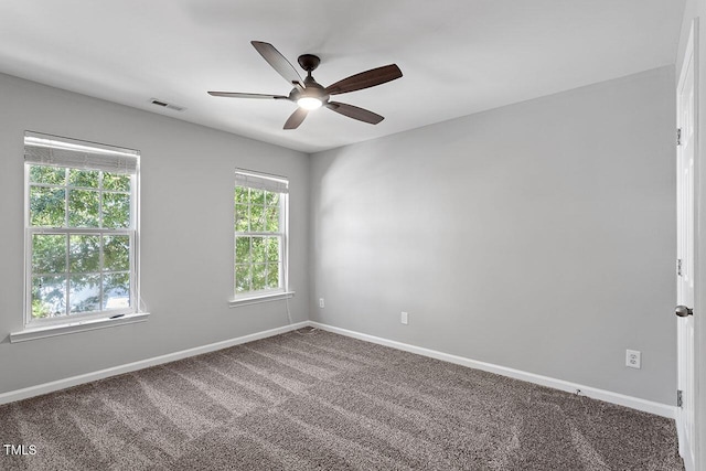 empty room with ceiling fan and carpet