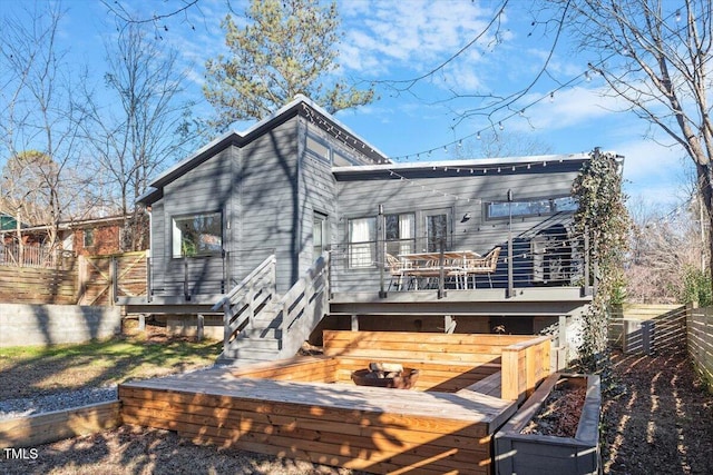 back of property with a wooden deck