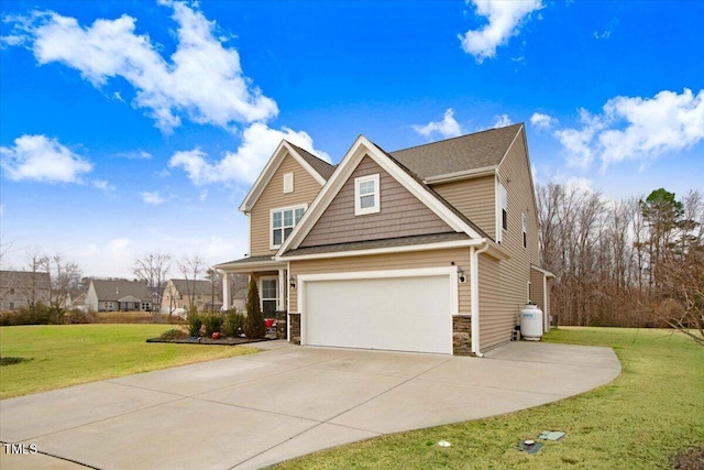 craftsman-style house featuring a garage and a front lawn