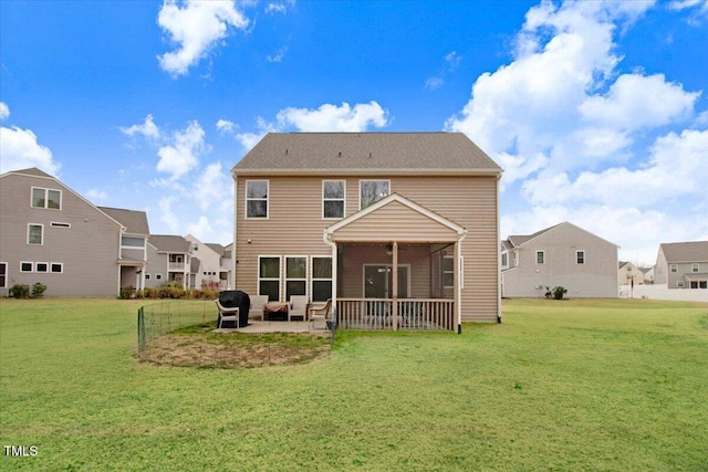 back of house featuring a yard, a sunroom, and a patio area