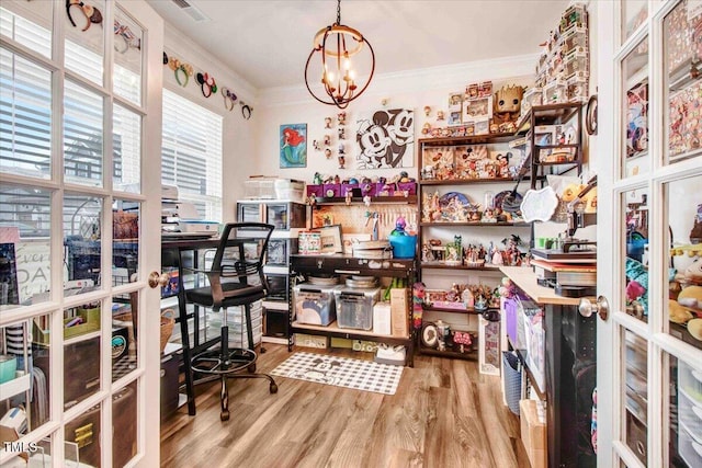 office featuring crown molding, a notable chandelier, and light wood-type flooring