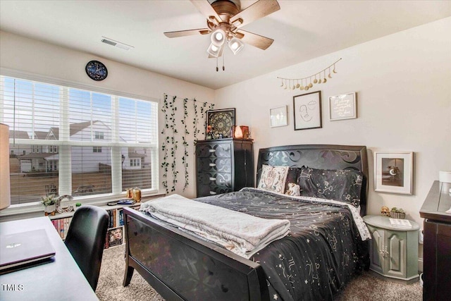 bedroom featuring ceiling fan and carpet