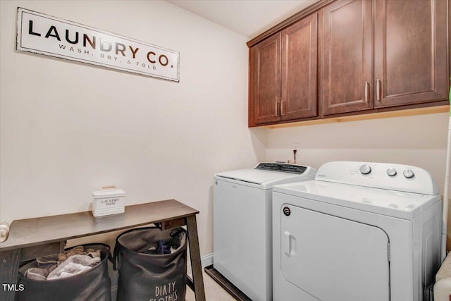 laundry room featuring cabinets and washing machine and clothes dryer