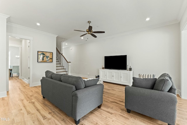 living room with crown molding, light hardwood / wood-style flooring, and ceiling fan