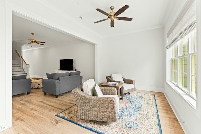 living room featuring crown molding, hardwood / wood-style floors, and ceiling fan