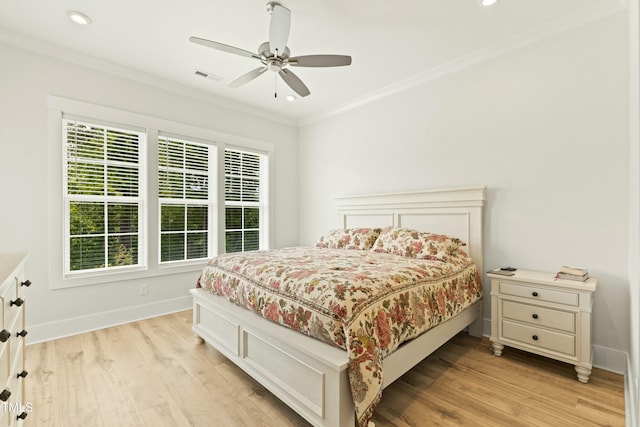 bedroom with ornamental molding, light hardwood / wood-style floors, and ceiling fan