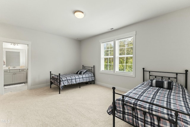 carpeted bedroom featuring ensuite bathroom