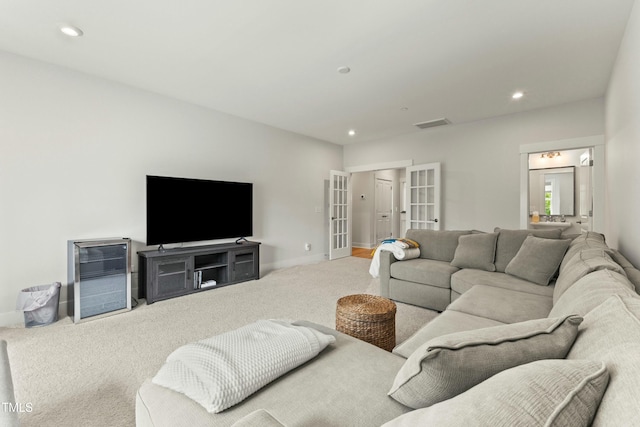 carpeted living room featuring french doors