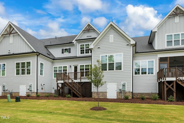 back of house with a wooden deck and a yard