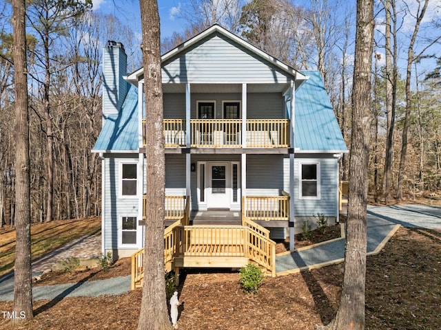 view of front of house featuring a balcony and covered porch