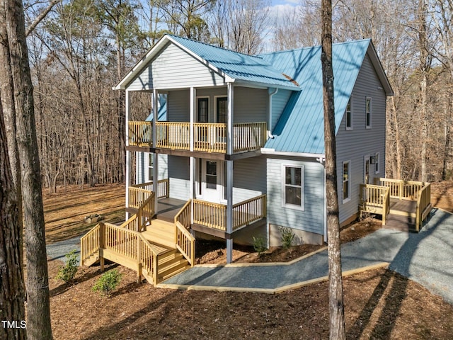 rear view of property featuring a balcony