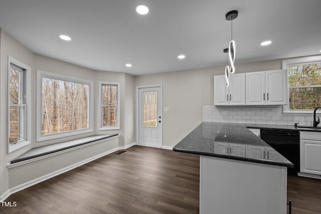 kitchen featuring dishwasher, white cabinetry, dark stone countertops, dark hardwood / wood-style floors, and decorative light fixtures