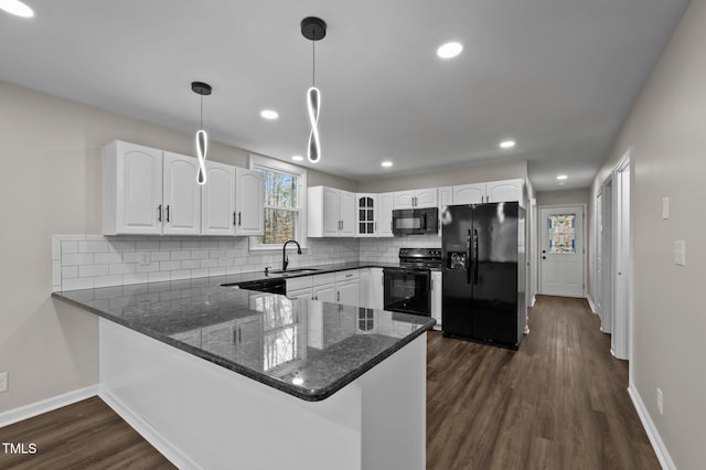 kitchen with sink, white cabinetry, hanging light fixtures, black appliances, and kitchen peninsula