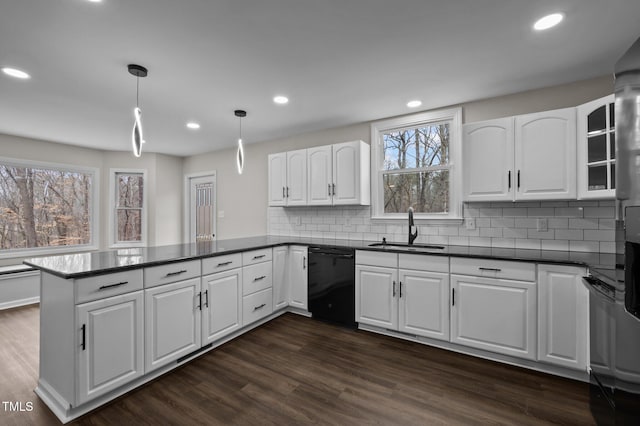 kitchen with sink, hanging light fixtures, black dishwasher, white cabinets, and kitchen peninsula