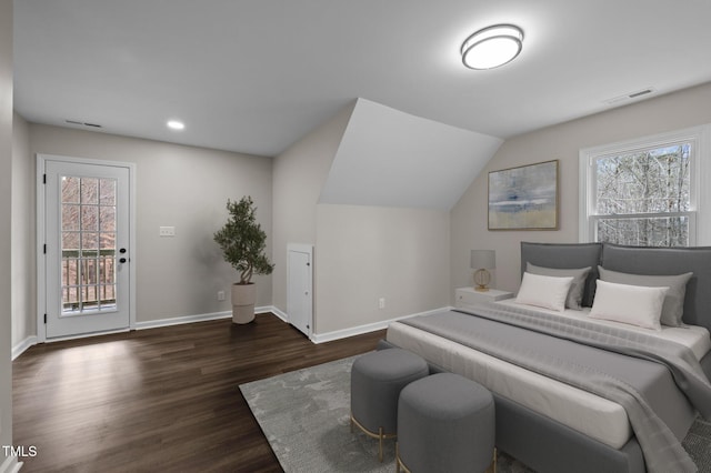 bedroom featuring access to exterior, dark hardwood / wood-style floors, vaulted ceiling, and multiple windows