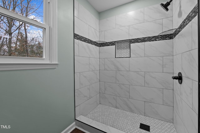 bathroom featuring a tile shower