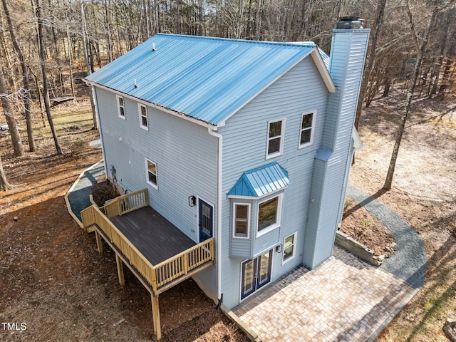 rear view of property featuring a deck