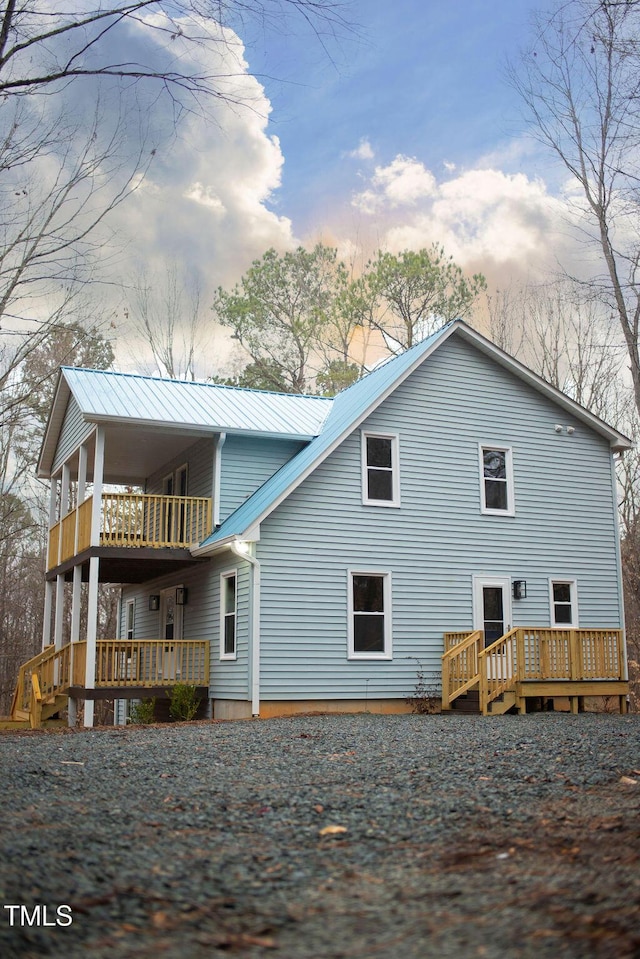 back of house featuring a balcony