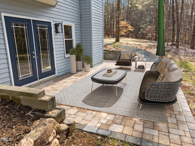 view of patio featuring an outdoor fire pit and french doors