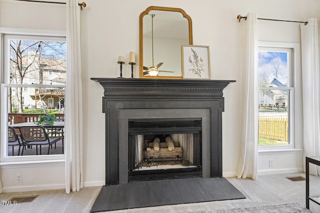 room details featuring carpet flooring, a fireplace, baseboards, and visible vents