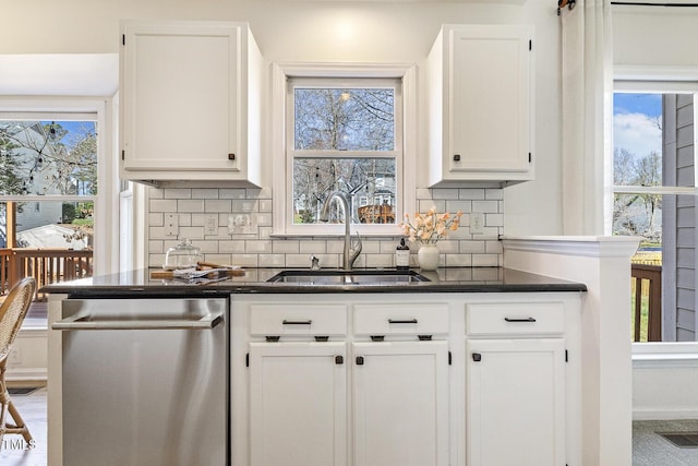 kitchen featuring stainless steel dishwasher, white cabinets, visible vents, and a sink