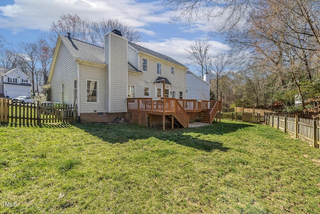 back of property with a deck, a yard, a fenced backyard, and a chimney