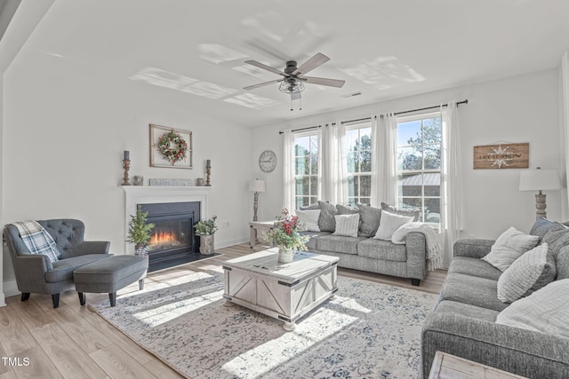 living room with ceiling fan and light hardwood / wood-style floors