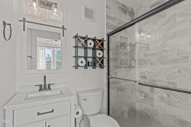 bathroom with vanity, an enclosed shower, and toilet