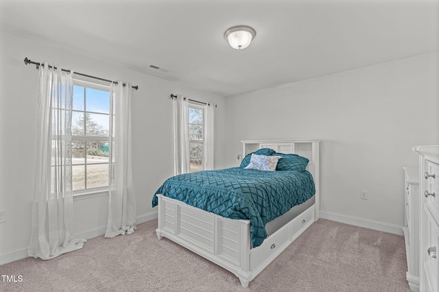 carpeted bedroom featuring multiple windows