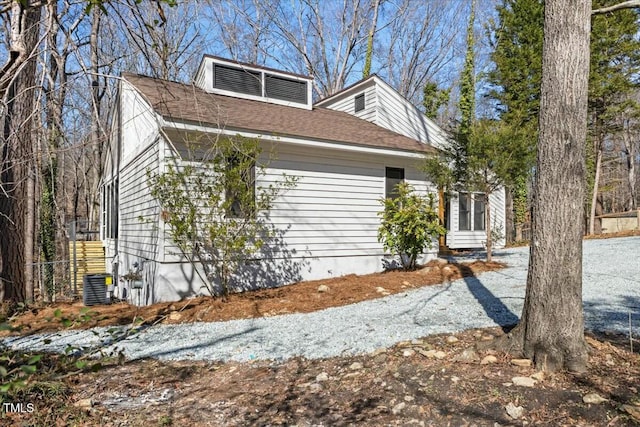 view of side of property with central AC unit