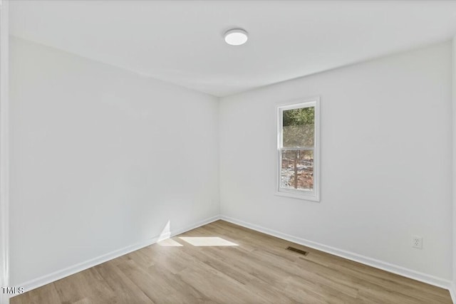 spare room featuring light hardwood / wood-style flooring