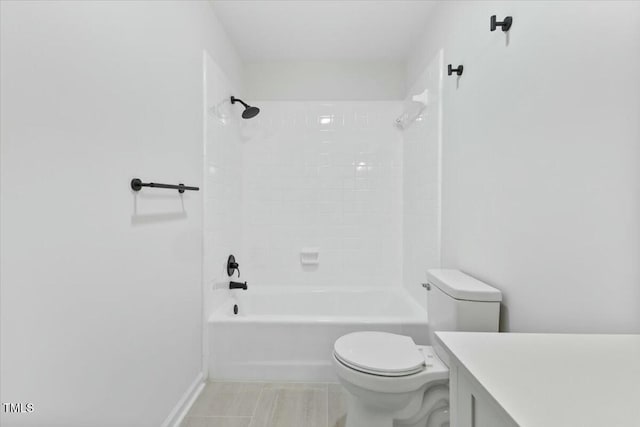 full bathroom featuring tiled shower / bath, vanity, and toilet