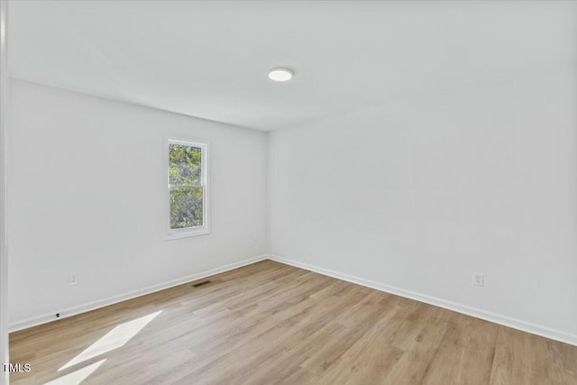 unfurnished room with light hardwood / wood-style flooring